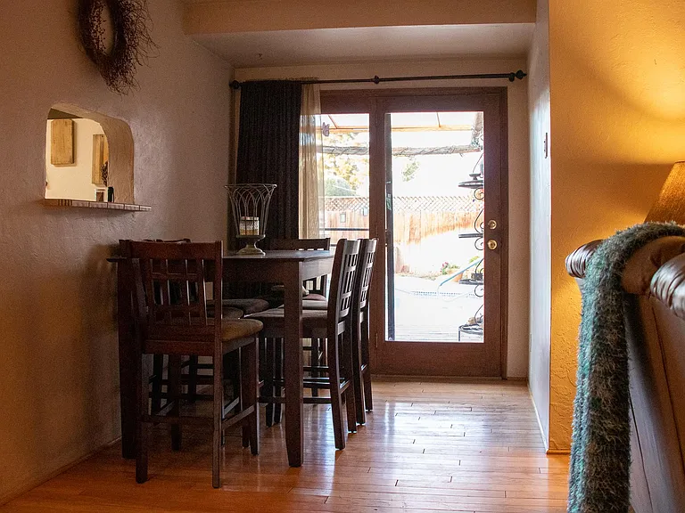 Dining space and one of the three doors leading to the backyard.