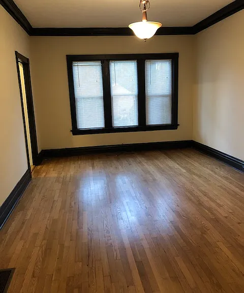 Spacious dining room with original crown molding, woodwork, and hardwoods