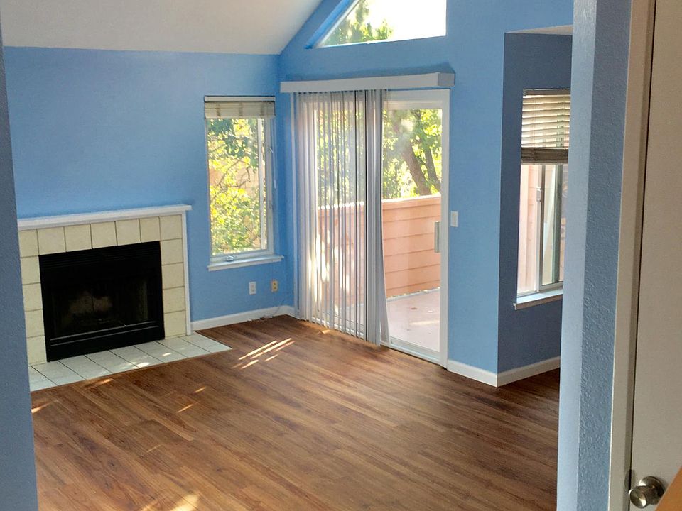 Living room with fireplace, high ceiling and new luxury vinyl plank (LVP) floor