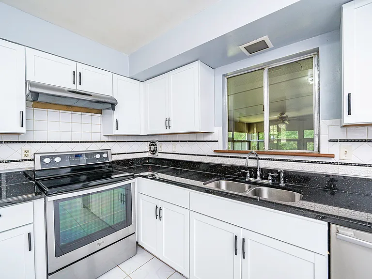 The kitchen sink window overlooks the Florida room/backyard.