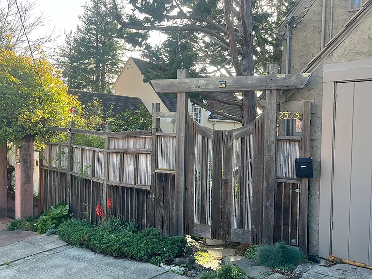 Redwood Fence and gate invite you home.