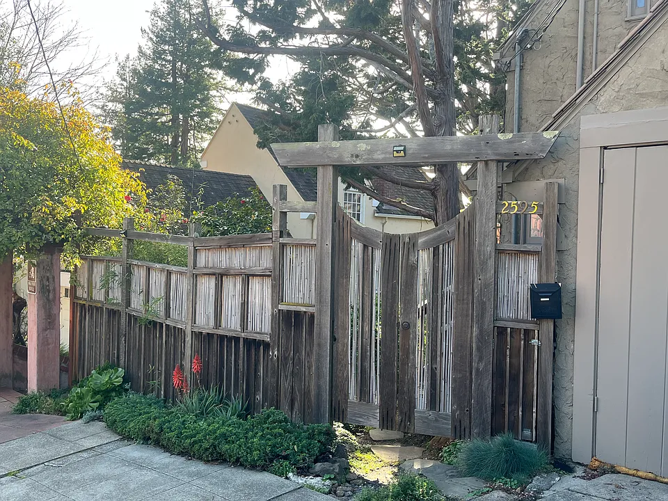 Redwood Fence and gate invite you home.