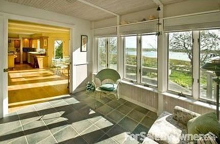 Sun drenched den with 270 degree views
						:
						Well positioned sun room with 1/2 bath, wet bar and pocket doors for privacy