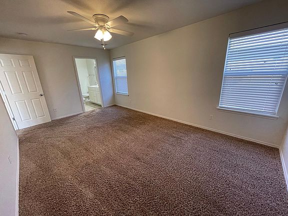 2nd photos of large master bedroom with ceiling fan and en suite bathroom with walk-in closet