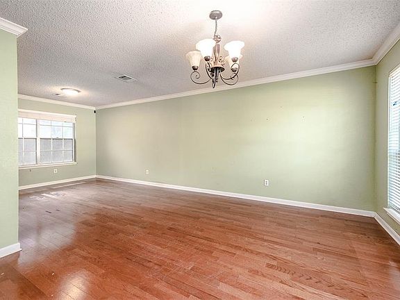 Make memories gathered around the table with your family and friends! This dining room features high ceilings, crown molding, custom paint, large windows, and a beautiful chandelier!
