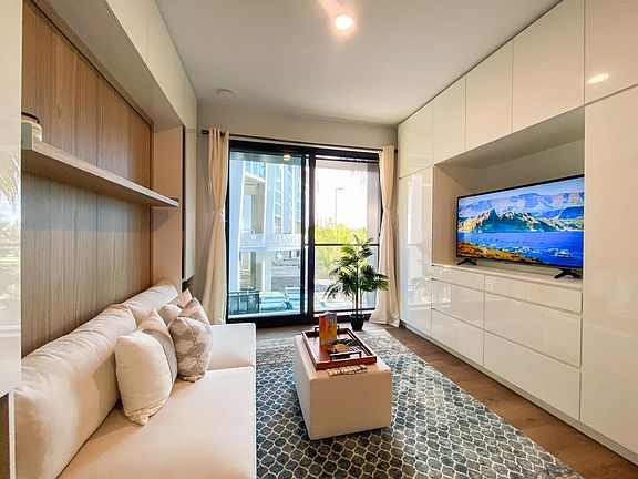 Transition from Murphy bed to sofa-living room.