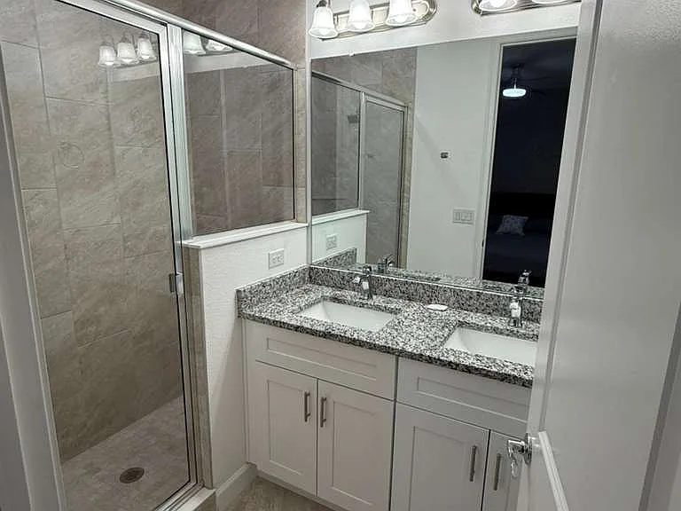Main room bathroom with two washbasin and separate pot.