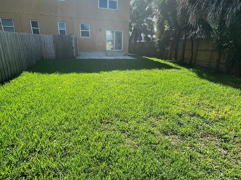 Beautiful and spacious backyard is fully fenced and has a nice paved patio and a shed