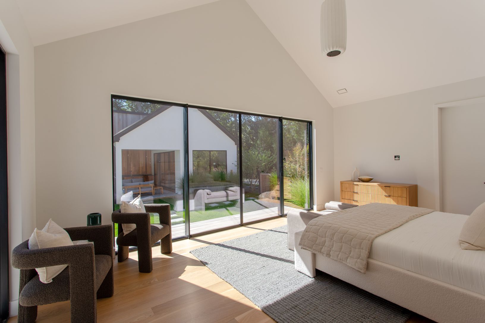  Primary bedroom on first floor, king bed, sliding doors that lead to the pool and patio