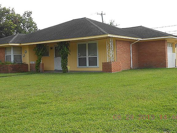 Corner view of the front of the home. Large front yard