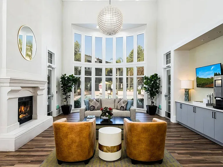 Spacious Clubroom with Large Windows, Fireplace, and Modern Furnishings