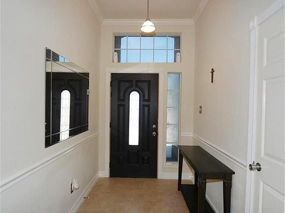  ENTRY WITH HALL CLOSET, CROWN MOLDING,  AND LEAD GLASS FRONT DOOR.
