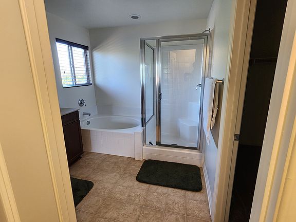 Large oval tub land separate shower.