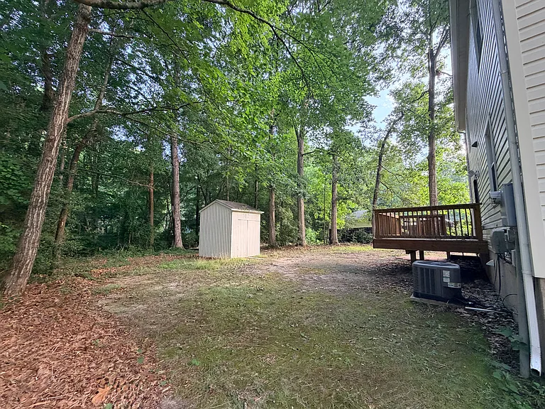 Private back deck, right off of kitchen, overlooking property