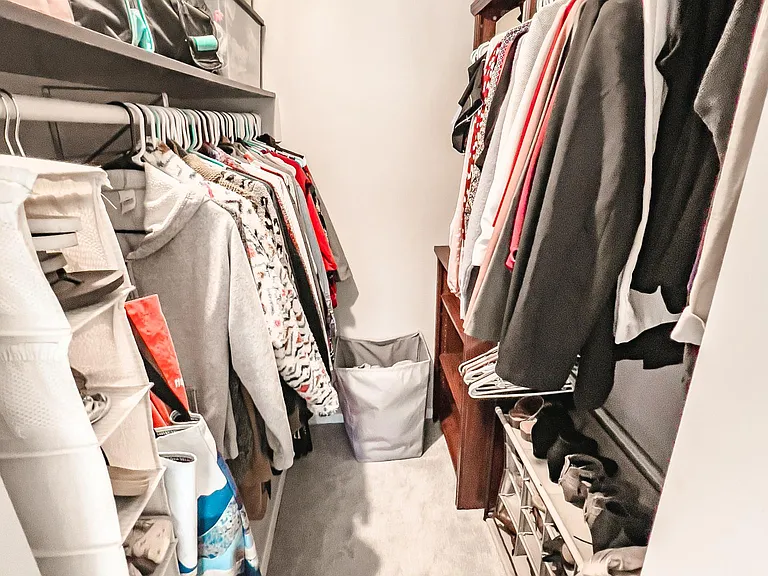 1 of 2 closets in the primary bedroom. Walk in with updated closet shelving.