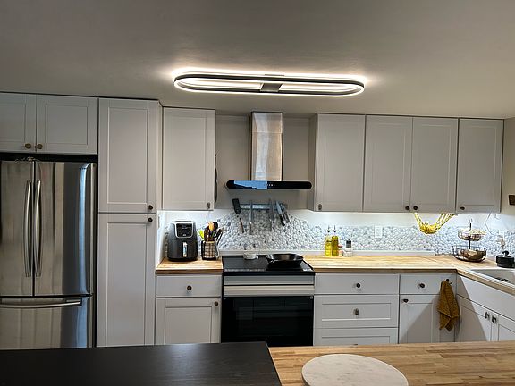The kitchen has recently been updated with butcher block counters, a new induction stove/electric oven, new vent hood, and new faucet. The large fridge, dishwasher, and washer/dryer are just a few years old.