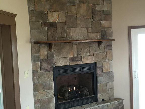 Stone fireplace with gas log set