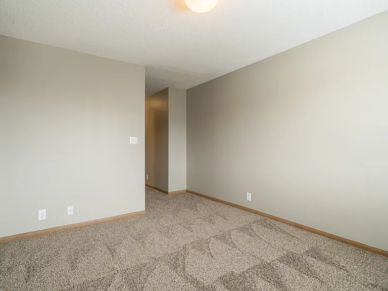 Retreat to your quiet, comfortable bedroom with soft carpeting, natural light, and plenty of space to make it your own.