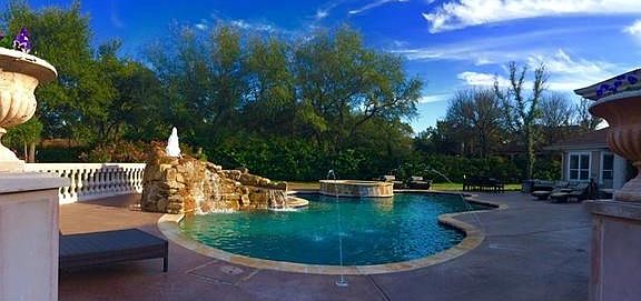 When making your way into the backyard, you are greeted with incredible outdoor retreat. The large outdoor living space with built-in grill, gorgeous pool, spa and rock waterfall will without a doubt be the spot for future entertaining.