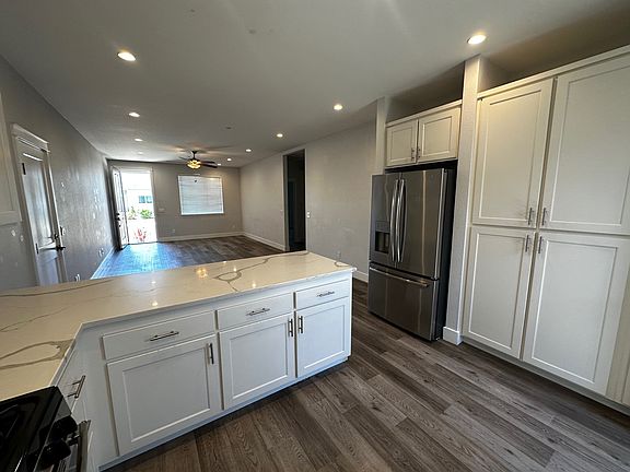 Kitchen lookign to the front door. Kitchen offers loads of storage.