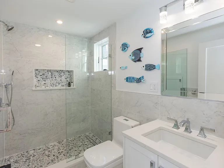 Downstairs bathroom. Overhead and hand held shower heads. Beach pebble shower