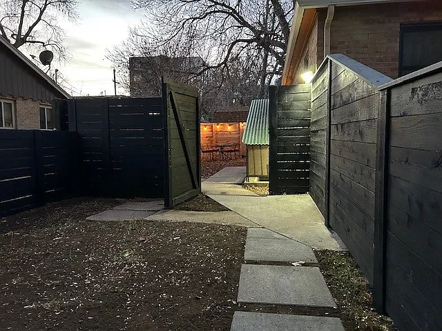 Evening view from front yard, automatic lights at gate.