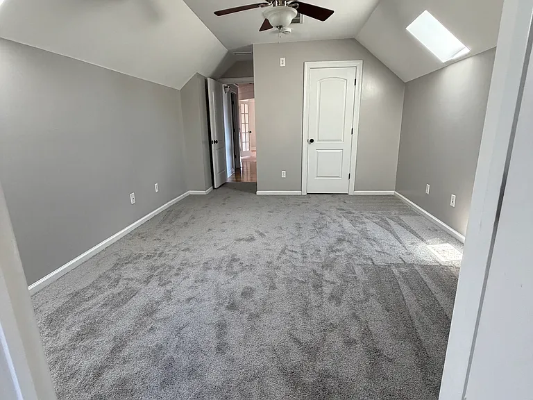 Guest bedroom with vaulted ceilings, skylights and an en-suite full bath_ideal for visitors, teens or use as a private home office with its own dedicated bathroom.