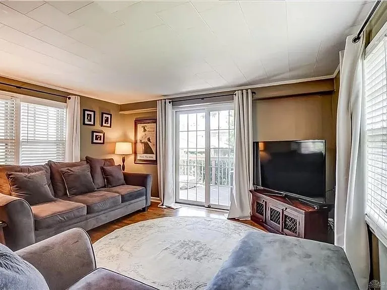 TV room/downstairs master suite looking north; French doors open onto the deck.