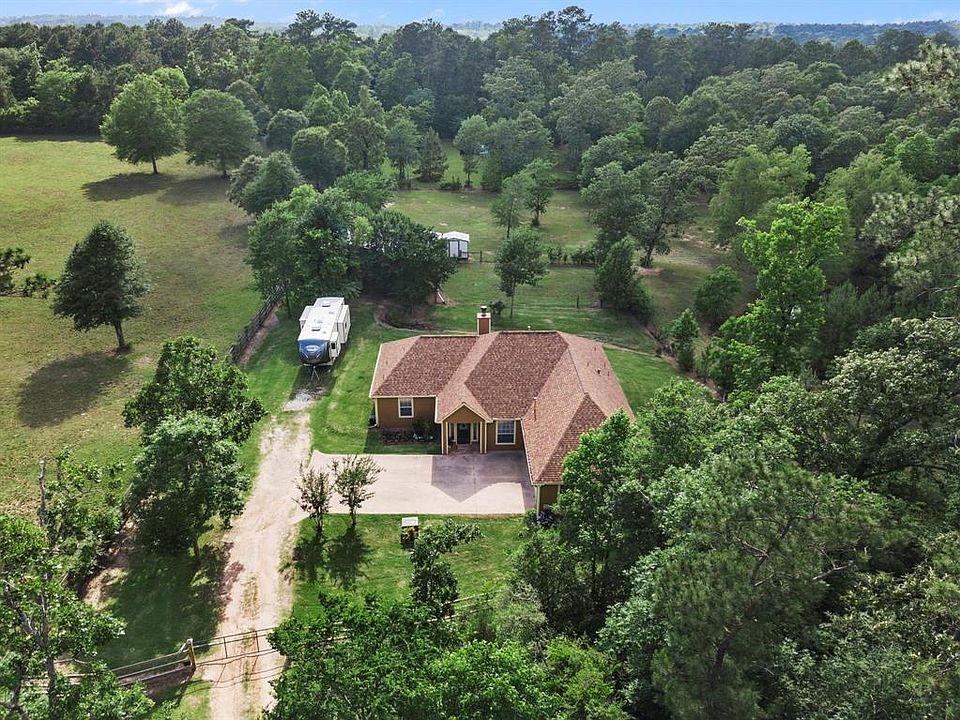 Welcome Home to your serene 3 acres. Relax and unwind on your secluded property which includes a stocked pond, back porch with an outdoor fireplace, birds and deer. Keep scrolling, you will be amazed by what you see.