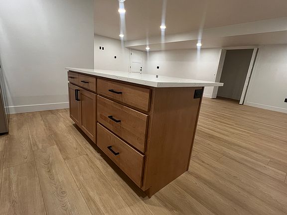 The spacious kitchen comes equipped with brand-new, top-of-the-line appliances, including an LG refrigerator, LG microwave, LG dishwasher, and a 36-inch Cosmo convection oven, ideal for culinary enthusiasts.