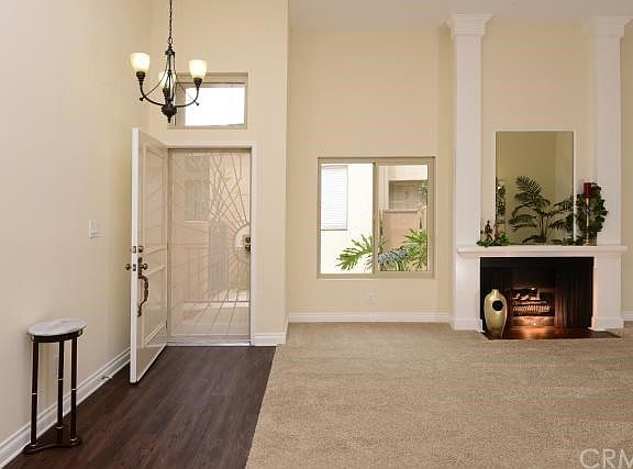 Vinyl tile (looks/feels like WOOD!) entry - crackling fireplace-HUGE living room-new carpet, paint, baseboards, light + + +