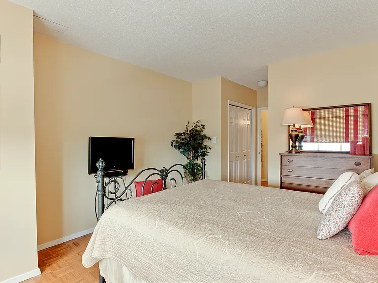 Looking from bedroom window toward entrance to bedroom, which shows one of two spacious closets.