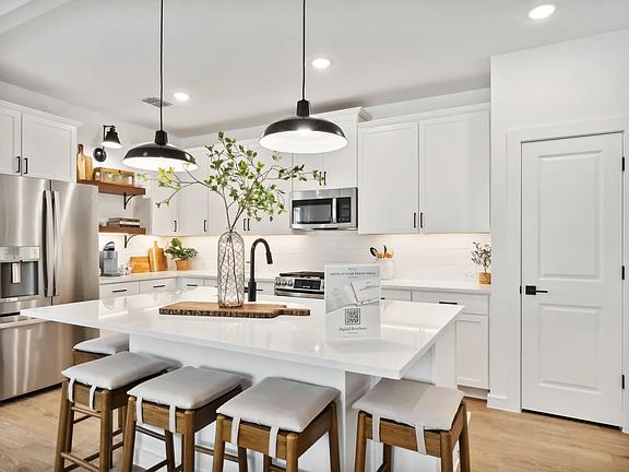 Kitchen with pendant lighting and floating shelves