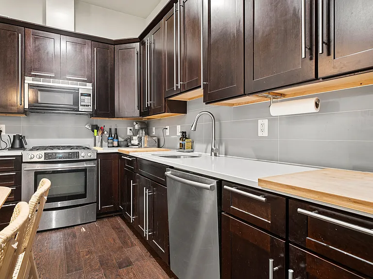 Modern Gourmet Kitchen with Dark Wood Cabinetry