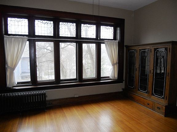 Bedroom w leaded windows and bookcase