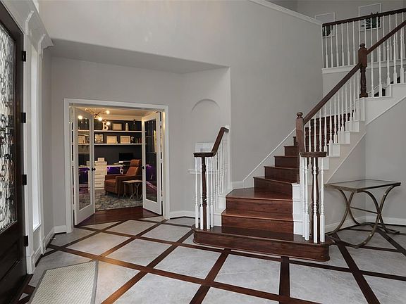 Lovely custom flooring in the entry plus updated light fixture