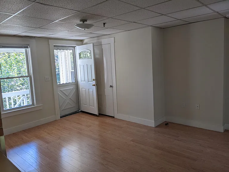 Entryway to the living room. There is a small space on the porch where you could have a chair and a small table.