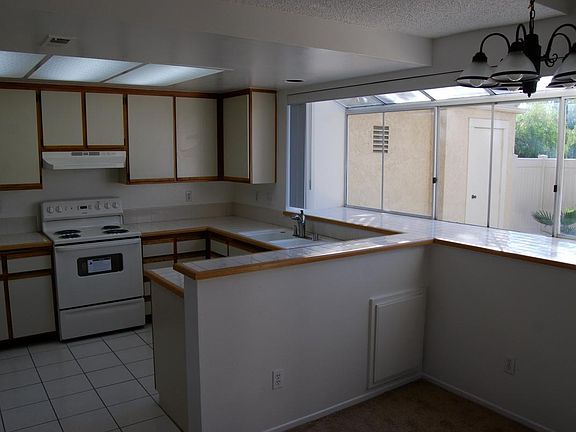 refrigerator sits just to the left out of picture. to the left of refrigerator is door to garage, and the the left of that is downstairs full bathroom