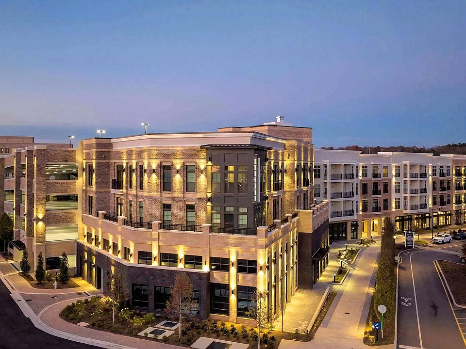 Apartment Building Featuring Multi-Level Parking and Corner Retail Space