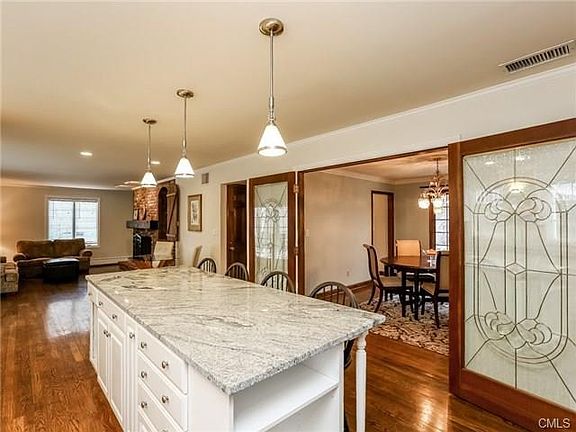 Beautiful custom built center island with granite counters and breakfast bar is open to family room and dining room.