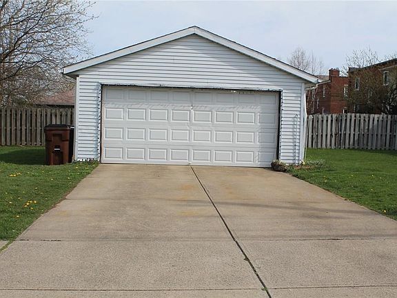 Garage is located on the side street (Pelham). One space is available inside the garage. Space for one more car in the driveway.
