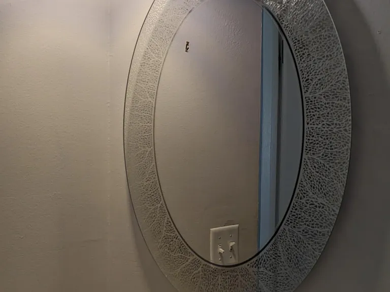Main floor powder room features a unique mirror and pendant light