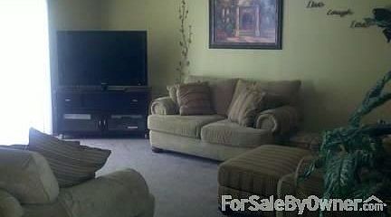 Family Room
						:
						Sliding glass door leads to covered back patio. Other door leads to garage.