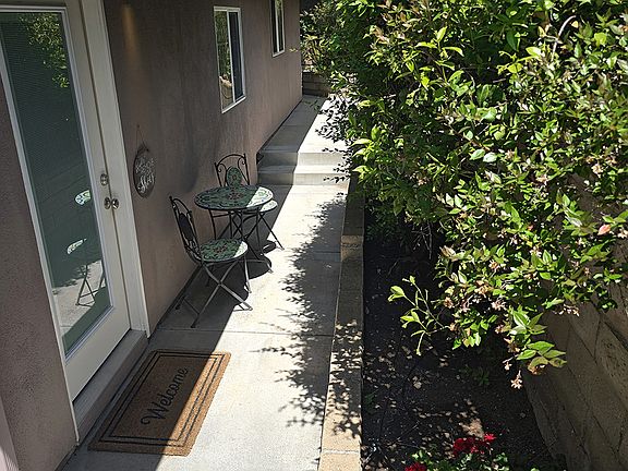 Gated private entrance and cafe table seating.