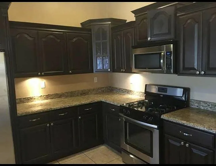 Kitchen with granite counter tops and stainless steel appliances.