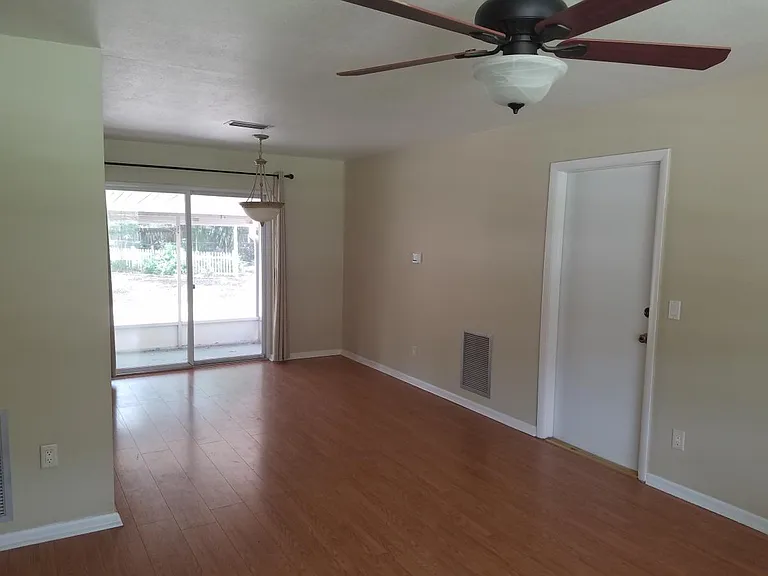 Large living room opens to screened patio