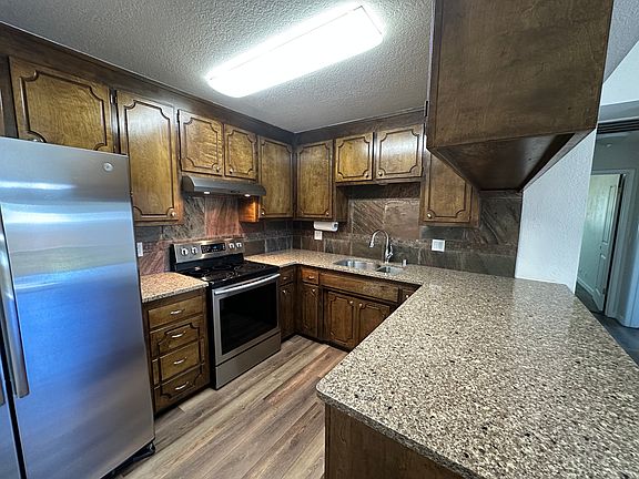Kitchen with Quartz Counters and a new Fridge and newer appliances.