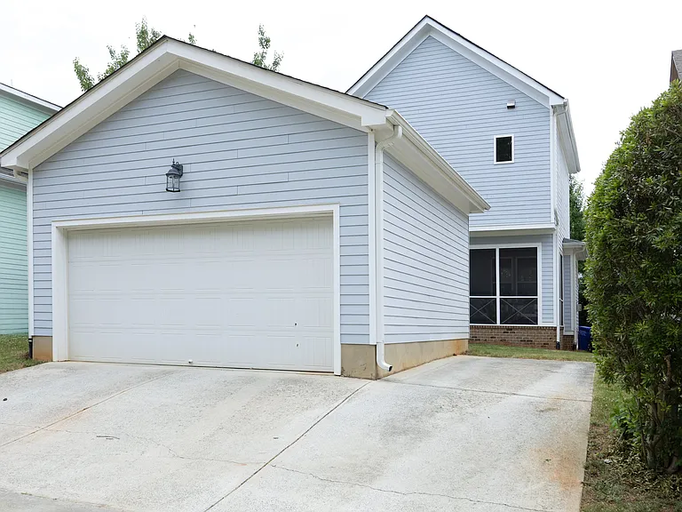 Back of house 2 car garage and extra parking pad