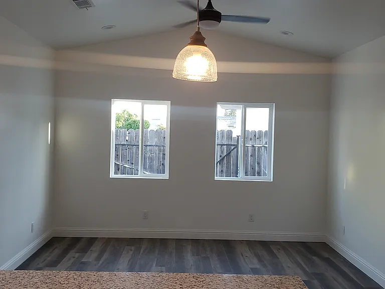 Vaulted ceilings in living room with recessed lights.