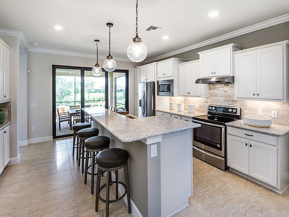 Model Representation Gourmet kitchen with stainless steel appliances, large island 42 white mapl